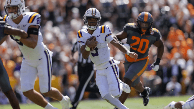 LSU quarterback Jayden Daniels tries to escape Tennessee defenders during Saturday's game at Tiger Stadium. -- Photo by Stephen Lew-USAToday/Reuters