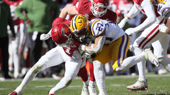 LSU running back Josh Williams (27) is tackled by Arkansas defensive back Latavious Brini (7) during Saturday's game at Donald W. Reynolds Razorback Stadium. -- Photo by Nelson Chenault-USA TODAY Sports/Reuters